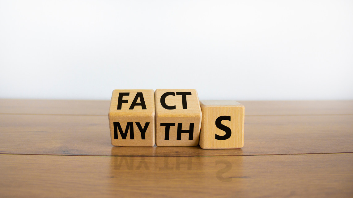 Turned cubes and changed the word 'myths' to 'facts' in a wooden table with white background