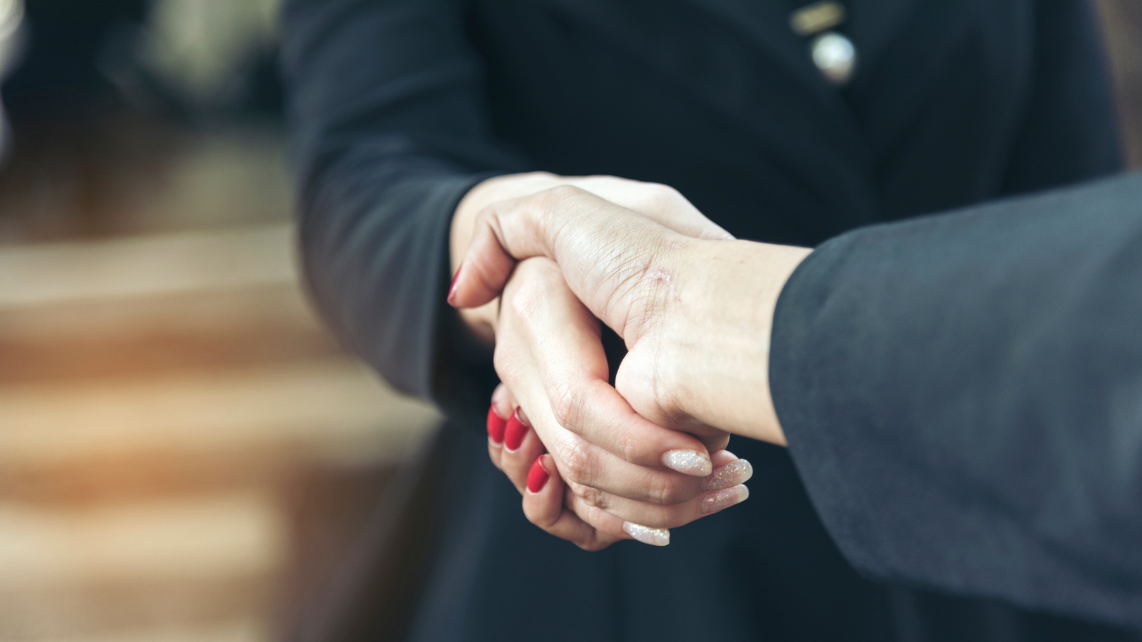 A businessman and a customer/client shaking their hands