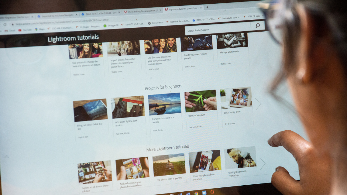 A woman using laptop to play a video on a website 