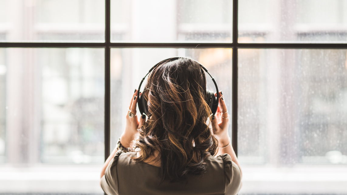 A woman listening on headphones
