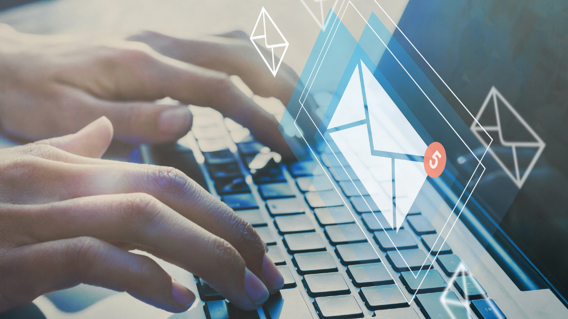 A man typing on his laptop with 3D email images appearing above it