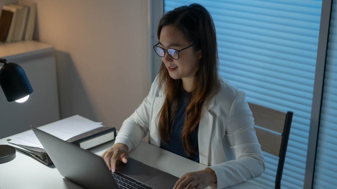 A woman working late at night in her workplace