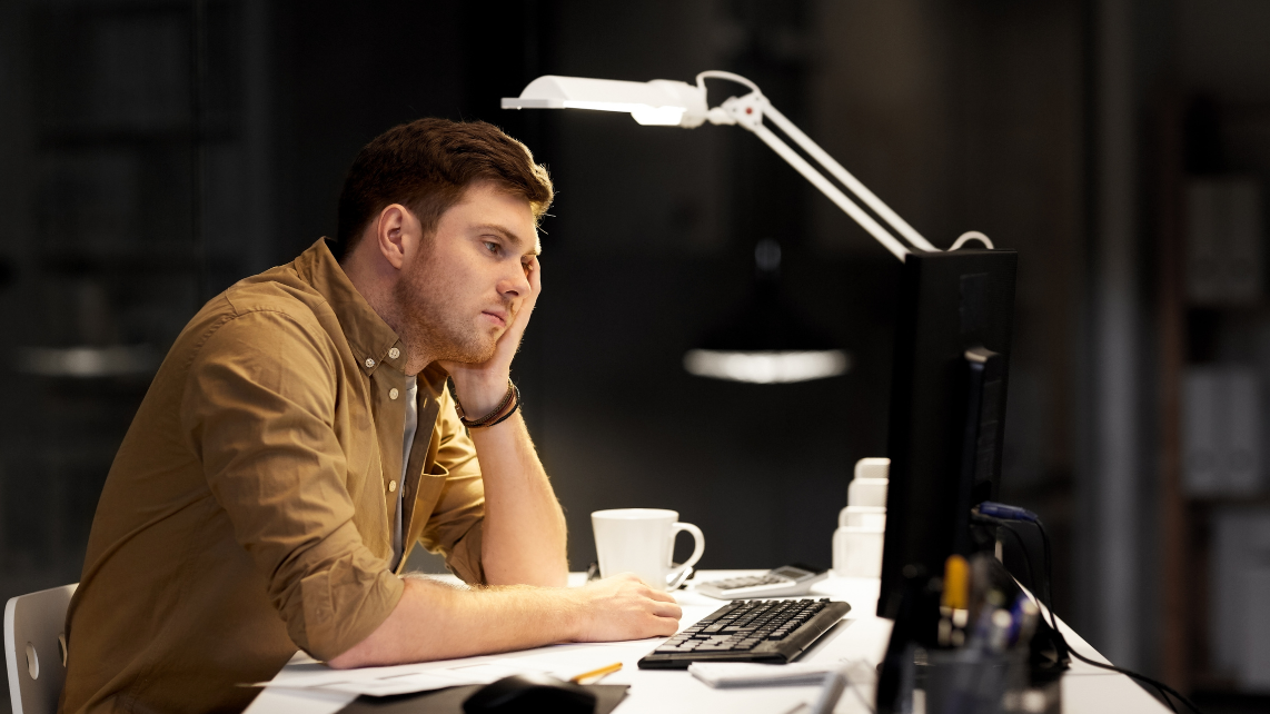 A bored businessman working late at night office