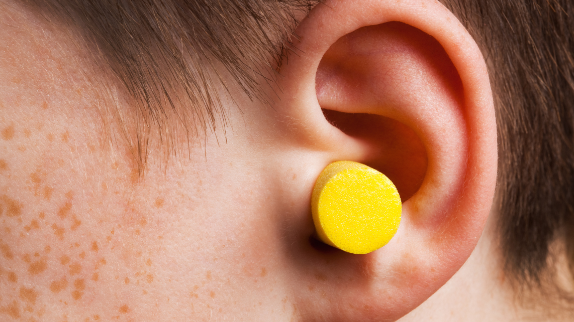 A man with earplug on his left ear