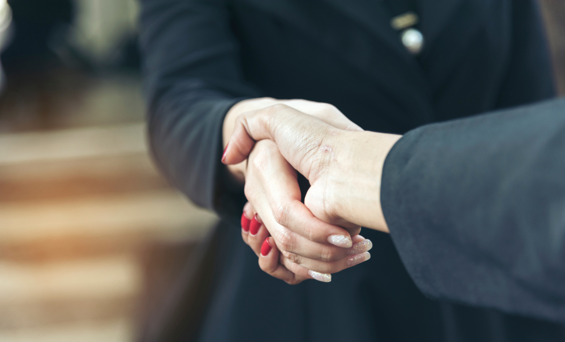A businesswoman shaking hands with a new client/customer
